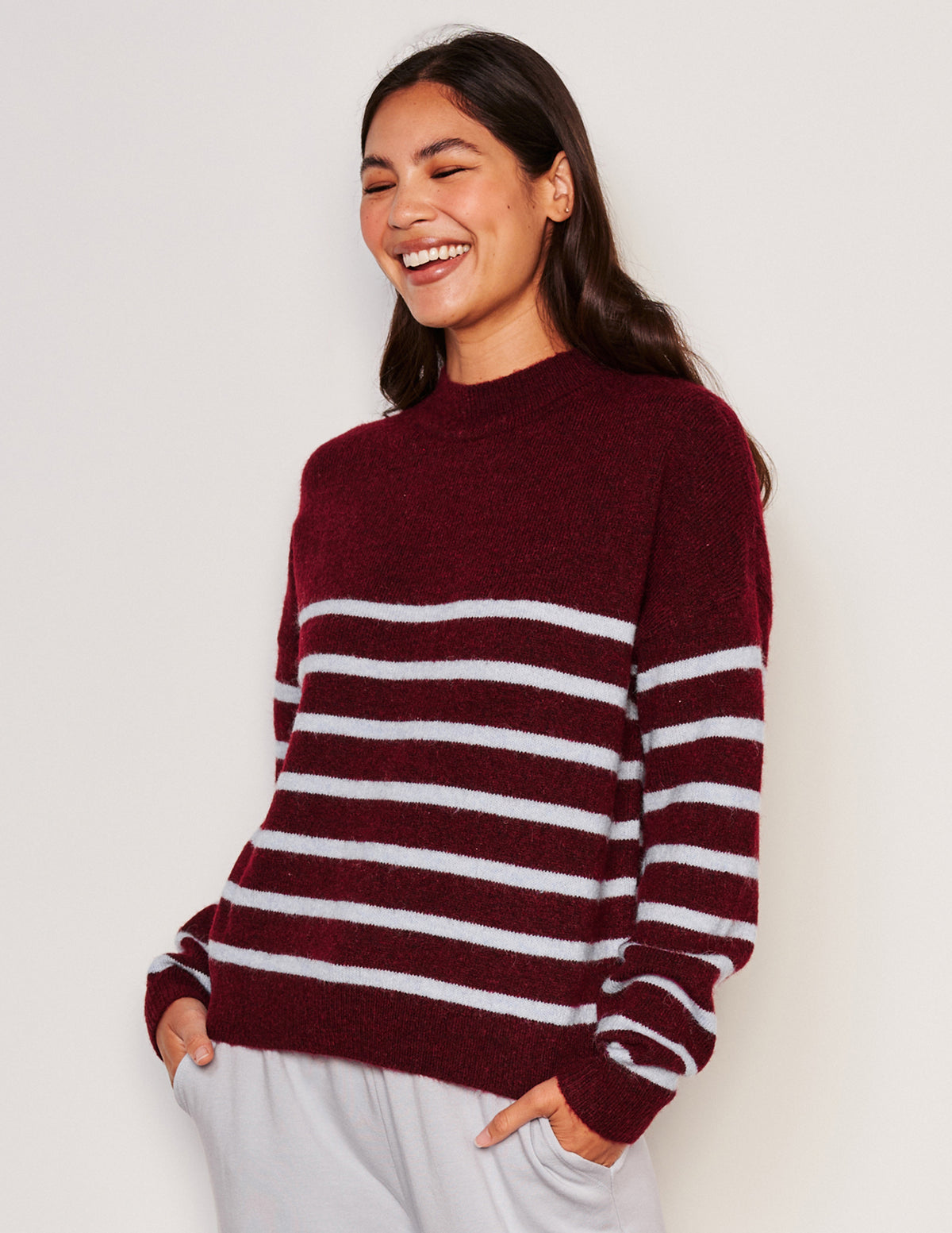 Sundry Stripes Mock Neck Cozy Sweater-model laughing  has her hands in her pocket