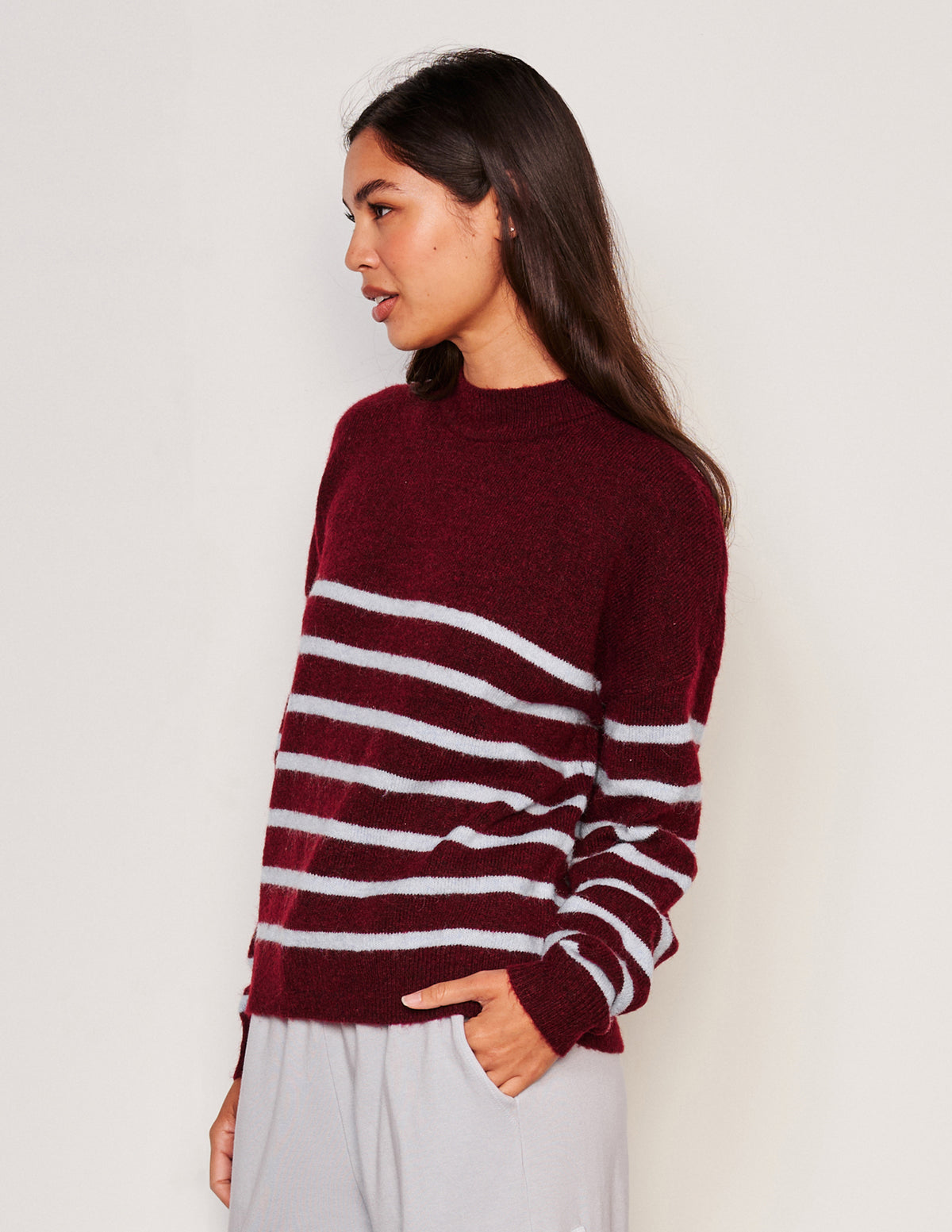 Sundry Stripes Mock Neck Cozy Sweater-side view model has one hand in her pocket