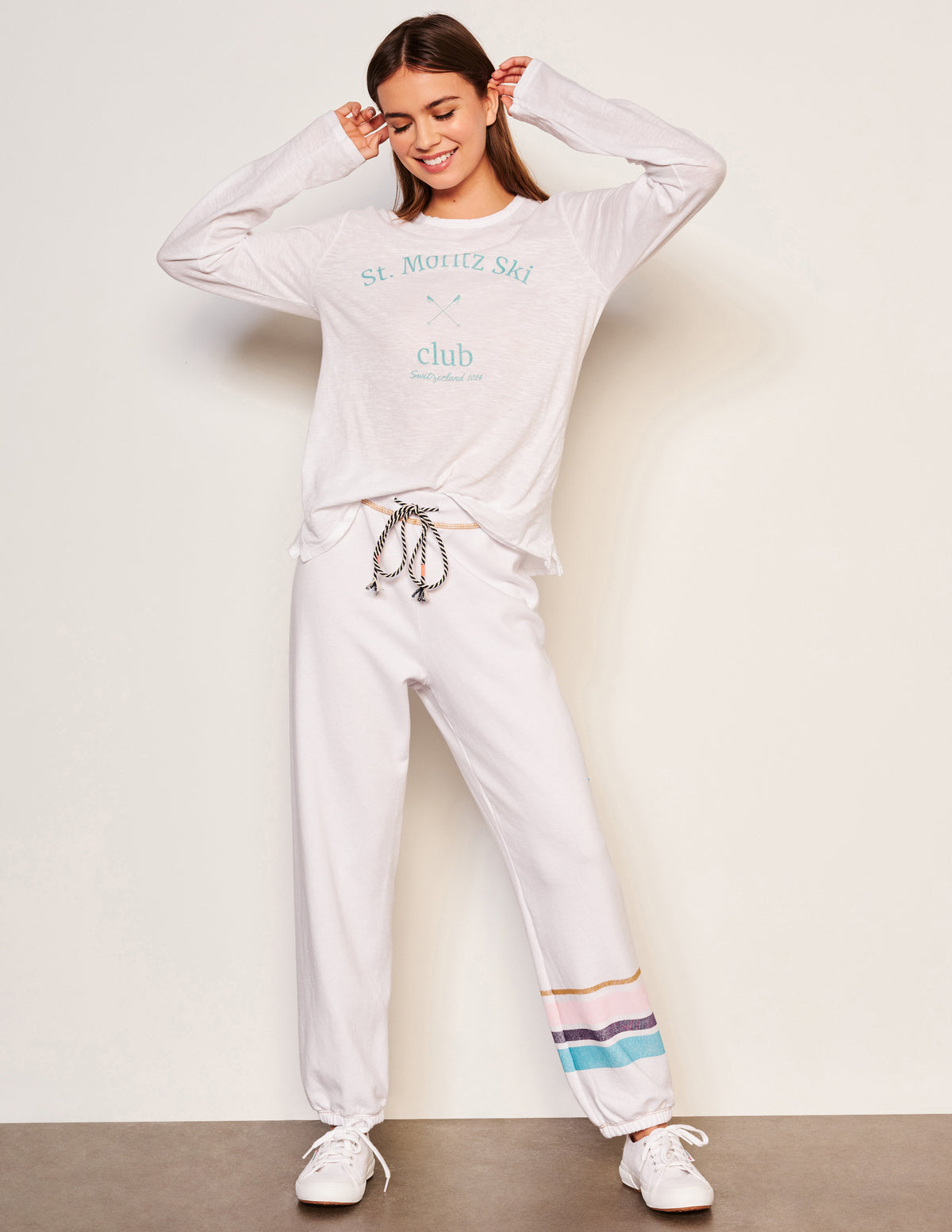 Sundry Ski Club Long Sleeve Crew in Optic White-full view model has her hands by her ears looking down