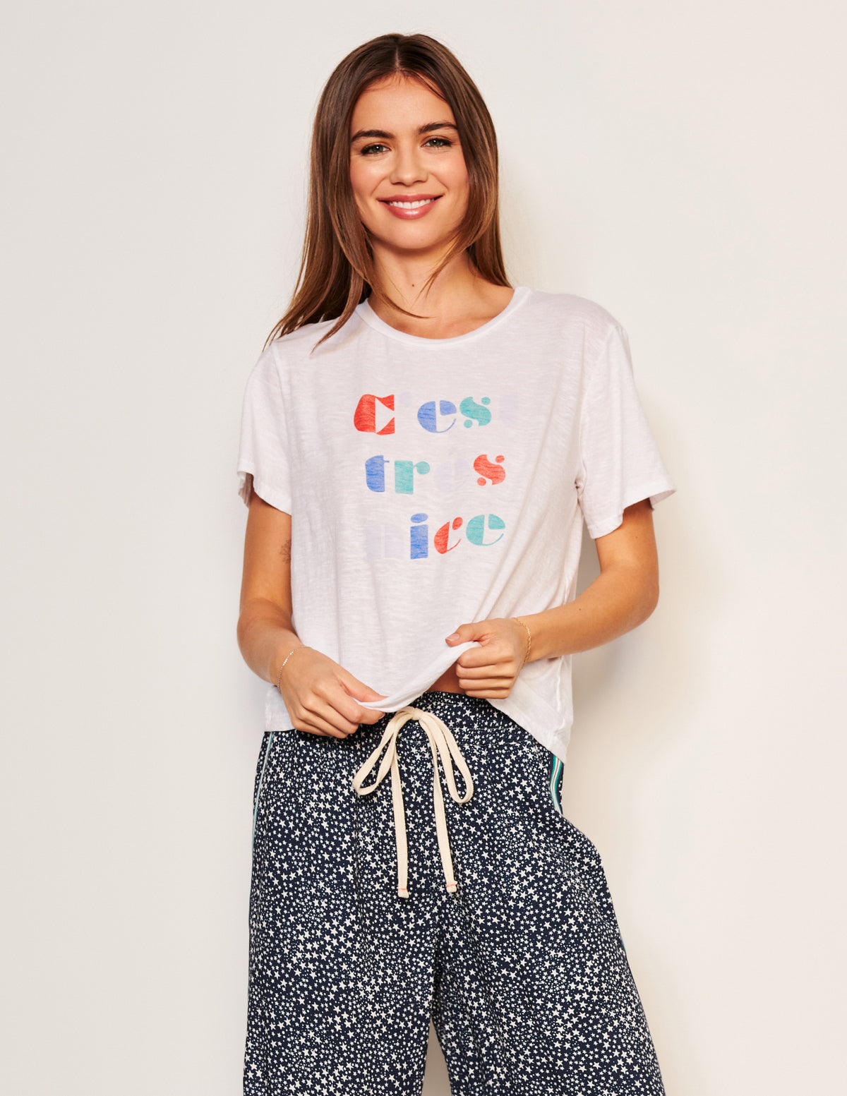 Sundry C&#39;est Crew Neck Tee in Optic White-3/4 front view model is smiling