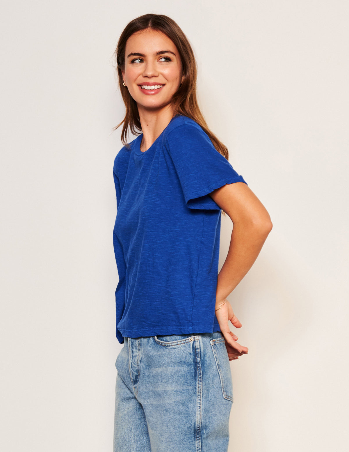 Sundry Crew Neck Tee in Symphony-side view and her hands are behind her back