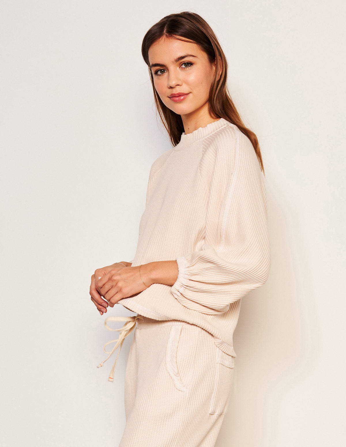 Sundry Thermal Mock Neck Dolman Shirt in Oyster-3/4 side model has her hands together 