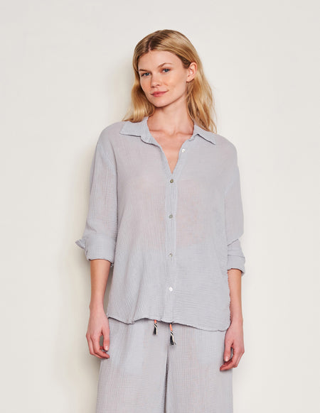 Sundry Classic Shirt in Blue Linen-model is smiling and one part of the shirt is tucket in