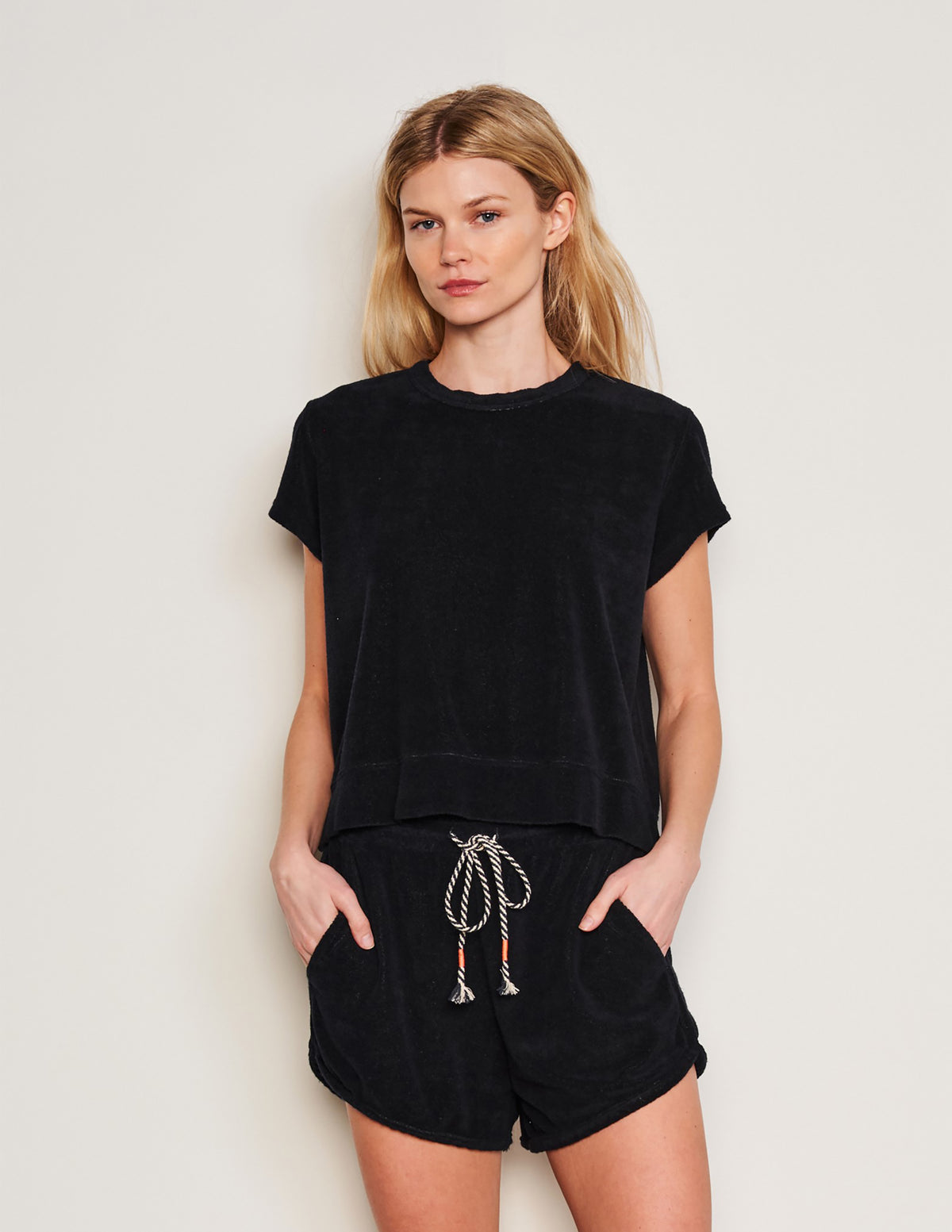 Sundry Courtside Pullover in Black-3/4 front view model has her hands in her pocket