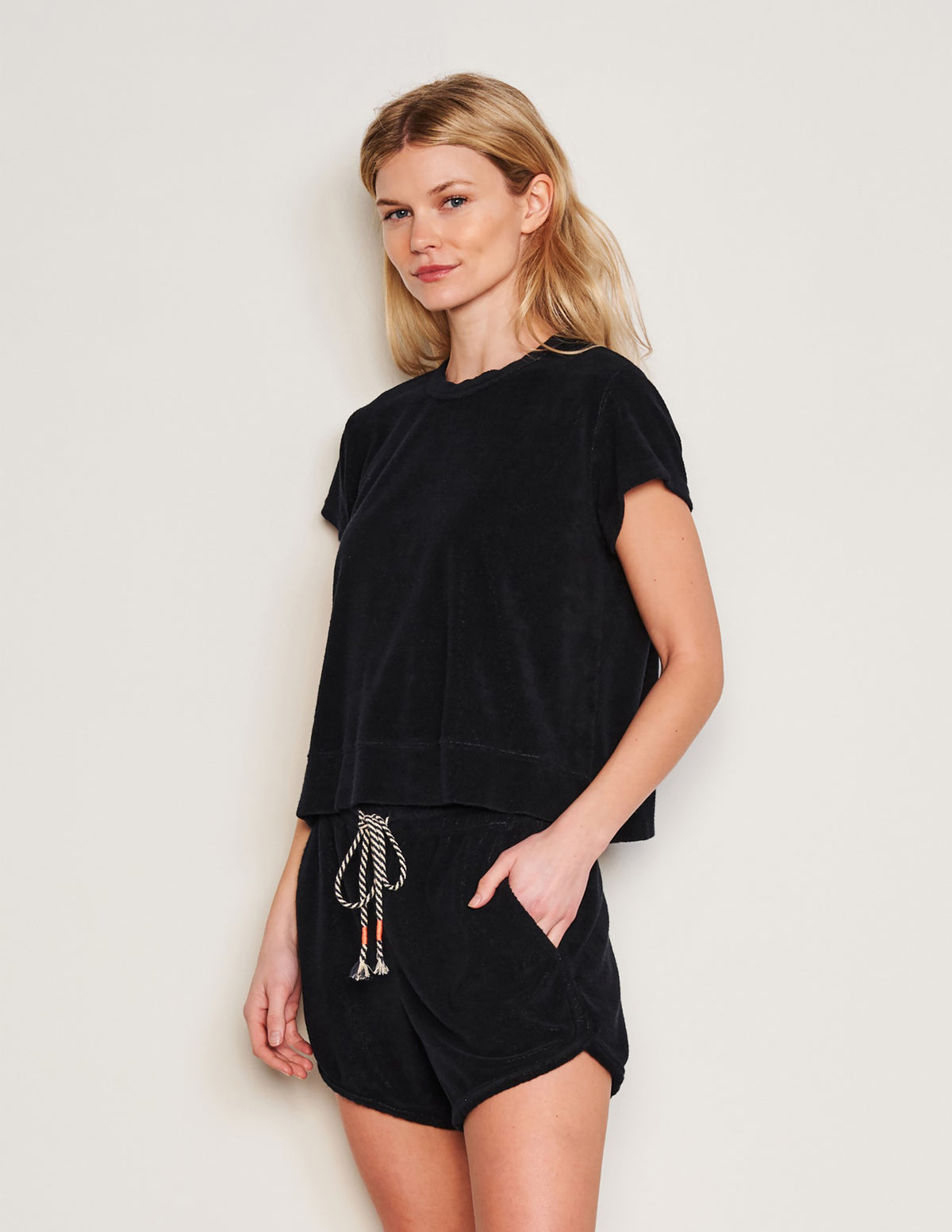Sundry Courtside Pullover in Black-side view model is smirking and has her hands in her pocket