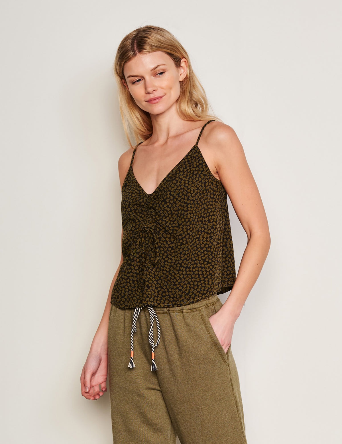 Sundry Clover Flutter Cami in Olive-model is looking to the side and has her hands in her pocket 