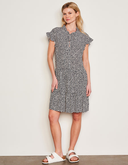 Sundry Clover Short Femme Dress in Optic White-models legs are crossed and has her hands on her hip and is laughing 