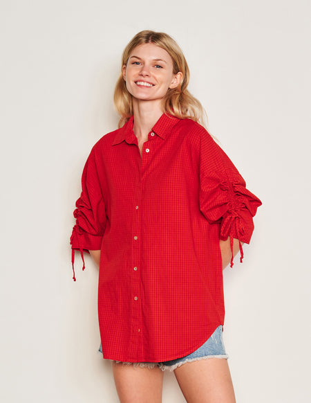 Sundry Beachside Check Short Shirt Dress in Burnt Red-model has her hands behind her back 3/4 front view