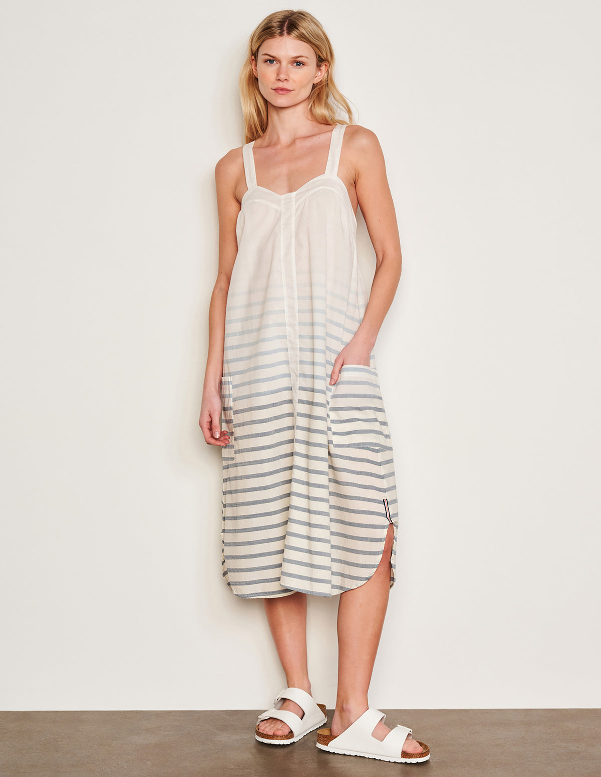 Sundry Changing Tide Stripe Midi Apron Dress in Deep Navy-model full view front ihas her hands in her pocket