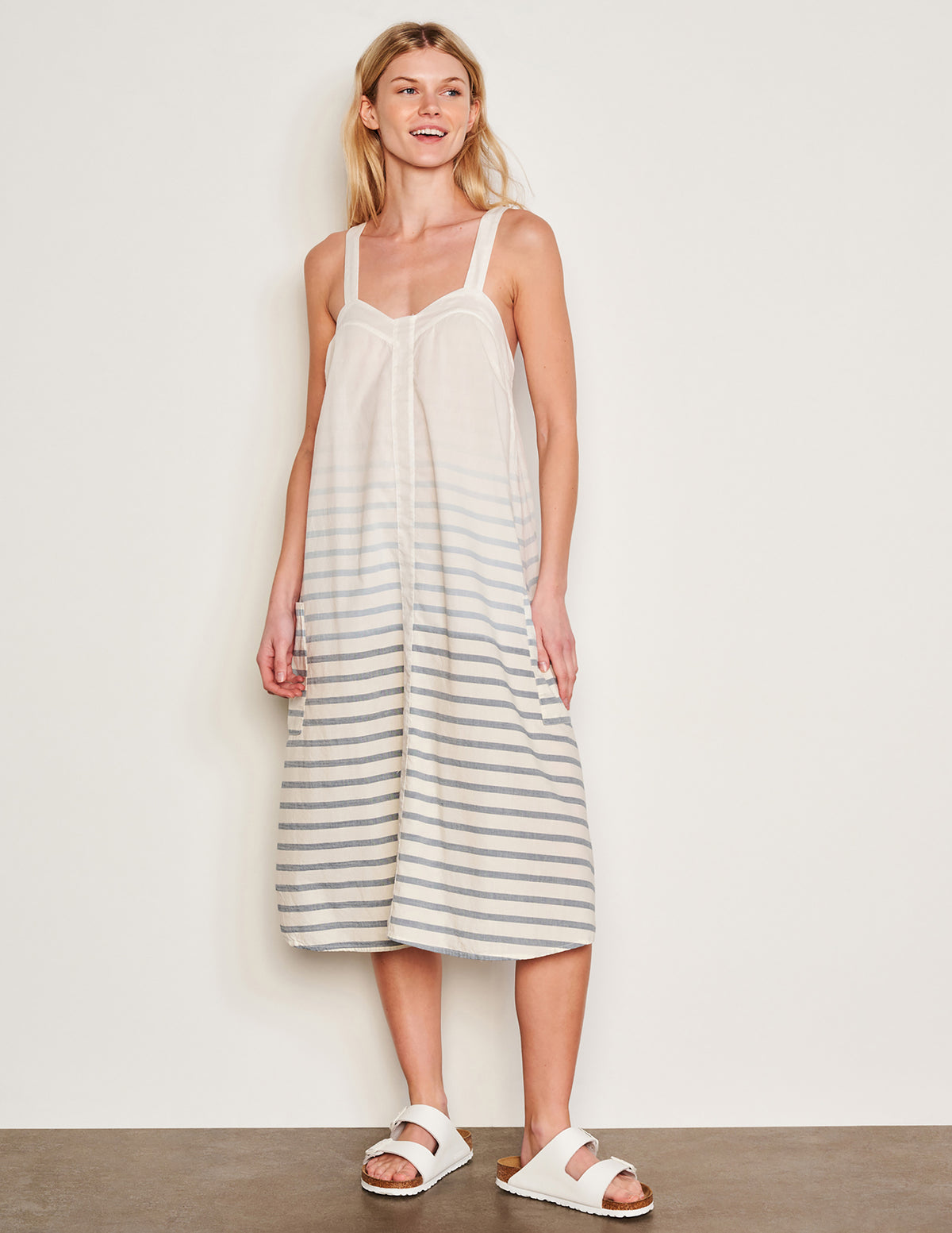 Sundry Changing Tide Stripe Midi Apron Dress in Deep Navy-full view front model is smiling and looking off to the side