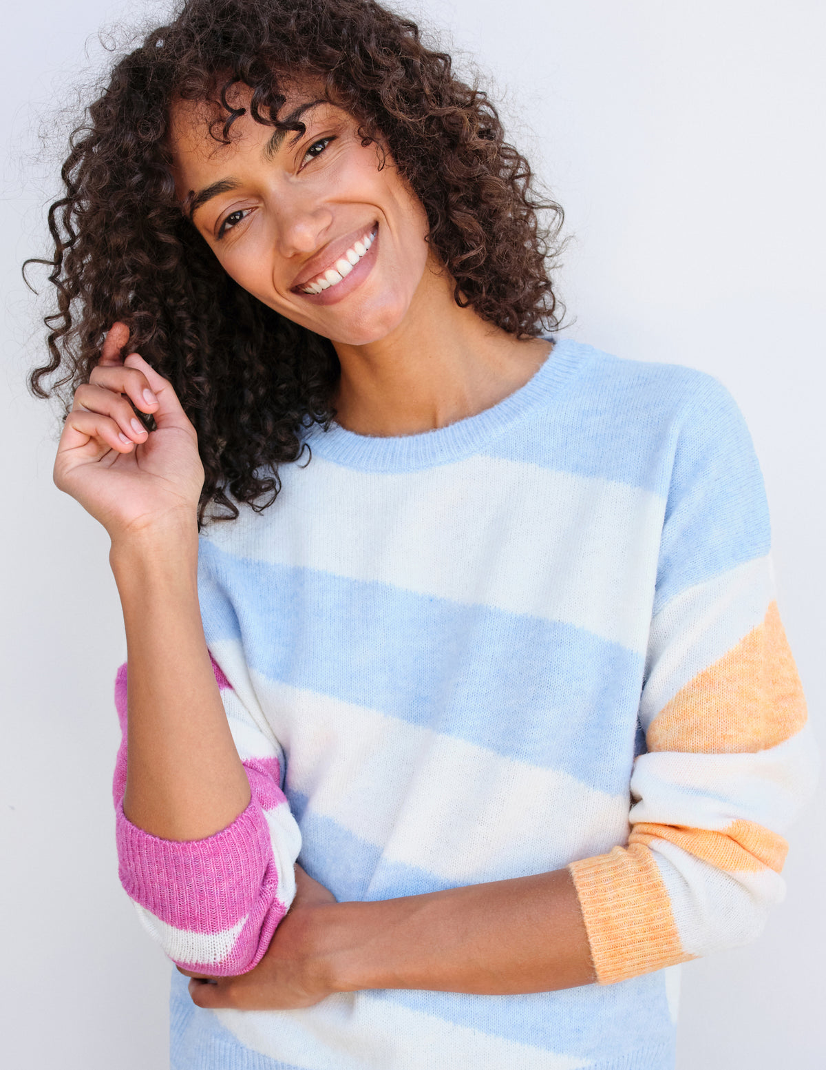 Sundry Diagonal Stripes Sweater in Flamingo/Sky/Sorbet-3/4  model is tilting her head and smiling